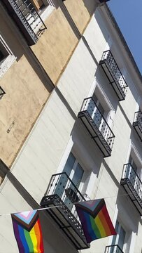 vertical format video Lgbt gay bisexual lesbian transgender nonbinary colored flags diversity lifestyle pride on balconies flags a sunny day spring summer concepro symbol equality freedom rainbow