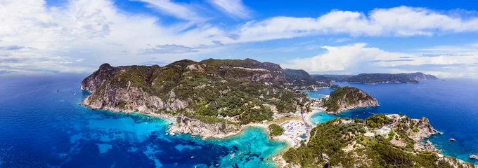 Fotobehang Corfu island. aerial drone view of most popular and beautiful Paleokastrtsa tourist village and resort, panorama of Ampelaki Beach. Greece, ionian islands. © Freesurf