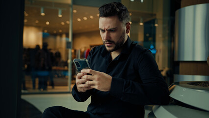 Disappointed upset annoyed man businessman male employee use phone gadget read bad notification...