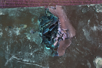 Damaged holes on X-ray film from being shot by a 11mm pistol bullet. Bulletproof armor technology.