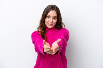 Young caucasian woman isolated on white background holding copyspace imaginary on the palm to insert an ad