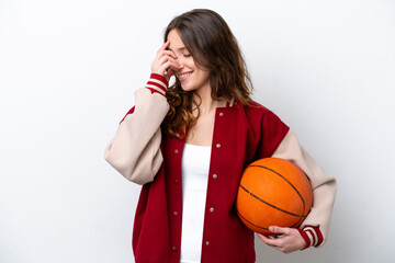 Young caucasian woman playing basketball isolated on white background laughing