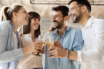 Group of happy business people toasting with wine at office party