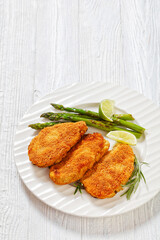 breaded chicken breasts with asparagus and lime