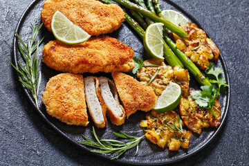 fried chicken breasts with asparagus and potatoes