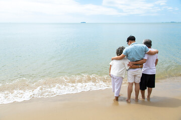 Fototapeta na wymiar Happy asian family on the beach summer vacation. Vacation summer beach holidays background