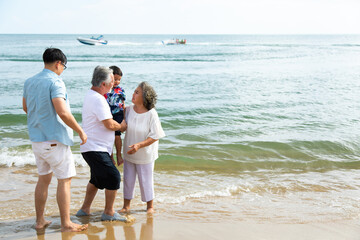 Happy asian family spending time together on the beach summer vacation.
