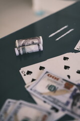 Blured Rolled 100 us dollars, 2 lines of cocaine, illegal drugs on a black glass table. Drug...