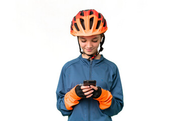 Teenager cyclist girl over isolated chroma key background sending a message with the mobile - obrazy, fototapety, plakaty