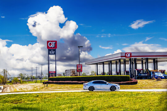 2020_05_14 Tulsa USA Quick Trip Convenience Store and gas station beside highway with semi truck parked and gas and car driving on road