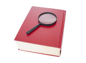 Magnifying glass close up and  dictionary with red hard cover  on a white background