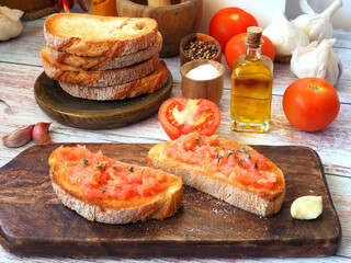 Toasted bread rubbed with fresh garlic and ripe tomato, then drizzled with olive oil - obrazy, fototapety, plakaty