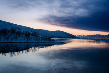 snowy landscape at sunset in coasline of tromso