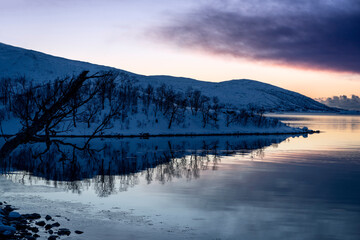 Fototapeta na wymiar snowy landscape at sunset in coasline of tromso