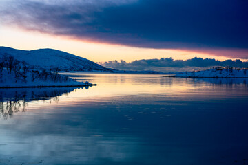 snowy landscape at sunset in coasline of tromso