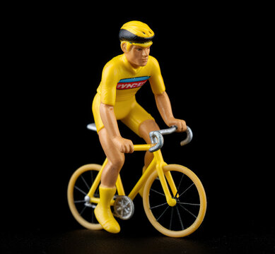 Yellow bicycle toy on the black background
