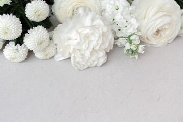Obraz na płótnie Canvas White flowers on light gray background with copy space. Template for text.