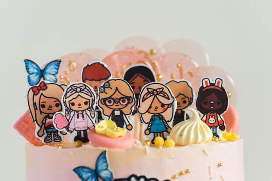 KYIV, UKRAINE - April 01: Birthday cake for a little fan of Toca Life World video game. Pink cake for a girl on the white background