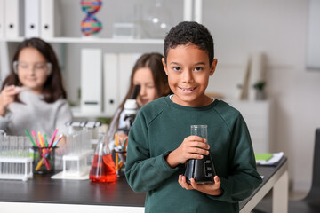 African-American little boy with conical flask in science classroom