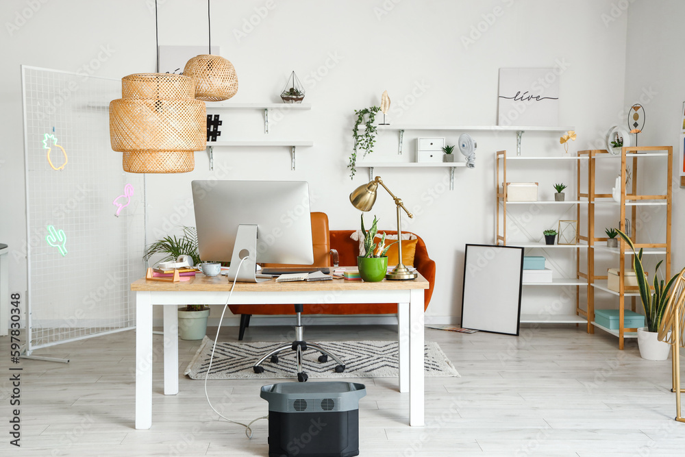 Wall mural interior of office with graphic designer's workplace, shelves and sofa