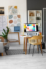 Graphic designer's workplace with computer in interior of office