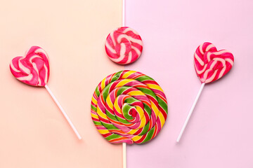 Sweet lollipops on pink and lilac background