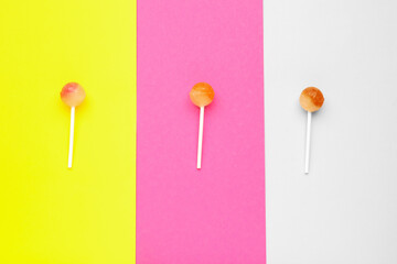 Sweet lollipops on colorful background