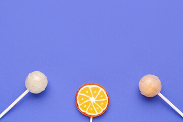 Sweet lollipops on blue background