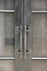 Wrought iron handle bars of a metal double door