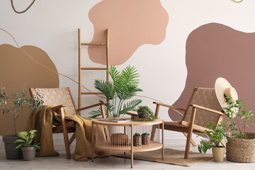 Interior of stylish living room with armchairs, houseplants and coffee table