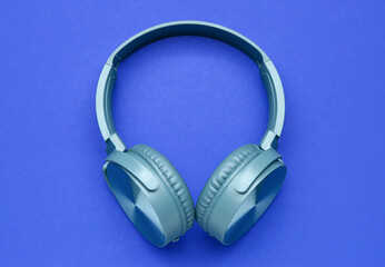 Modern headphones on blue background