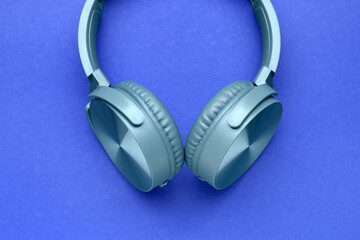 Modern headphones on blue background