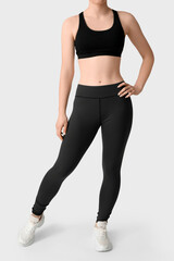 Fototapeta premium Sporty young woman in leggings on white background