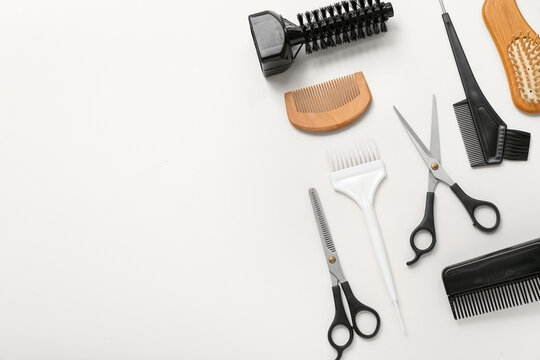 Composition with hairdressing accessories on light background