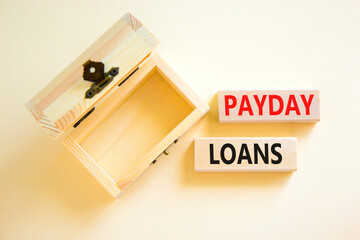 Payday loans symbol. Concept words Payday loans on beautiful wooden block. Beautiful white table white background. Empty wooden chest. Business and Payday loans concept. Copy space.