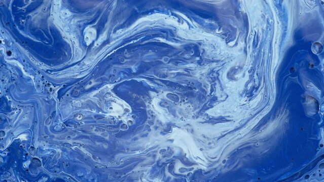 Blue pattern of liquid macro colors slowly flowing on surface. Abstract background. 
