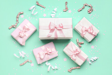 Gift boxes with bows, serpentine and confetti on turquoise background