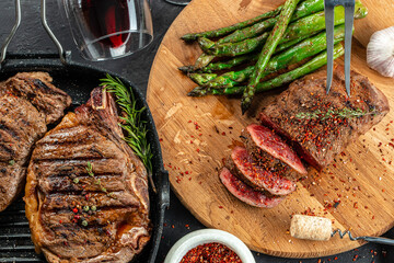 Barbecue steak with green asparagus and red wine. Healthy dinner or lunch