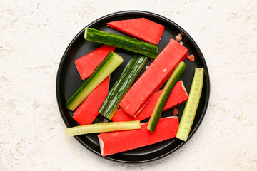 Plate with tasty crab sticks on light background © Pixel-Shot