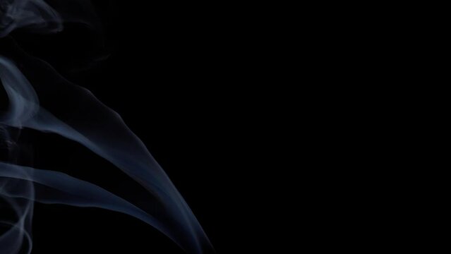 smoke of burning incense stick blowing away -black background (4k - slow motion)[ high quality ]