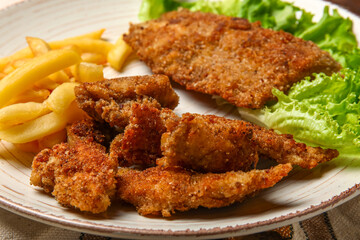 Plate of tasty fried codfish on table, closeup