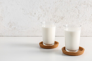Glasses with fresh milk on white background