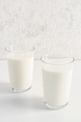 Glasses with fresh milk on white background