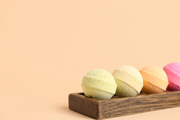 Stand with bath bombs on beige background, closeup