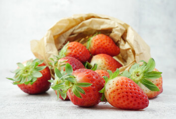 Strawberry on a stone base and inside a kraft paper bag.