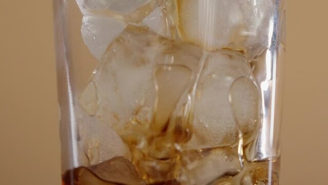 pouring whisky neat in square glass -black background (4k - slow motion)[ high quality colors]