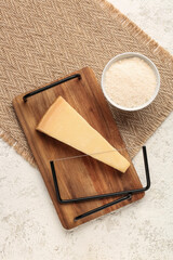 Tasty Parmesan cheese on light background