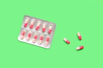 Blister of hormonal pills on green background