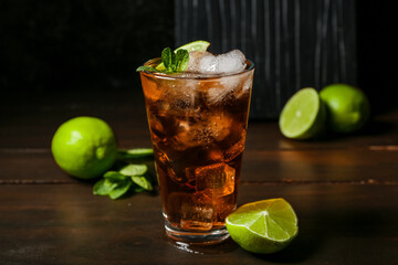 Glass of tasty Cuba Libre cocktail on table