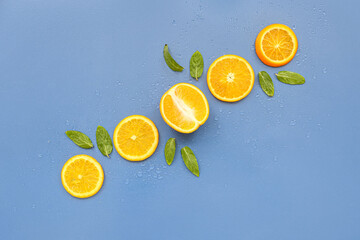 Orange slices and mint on blue background